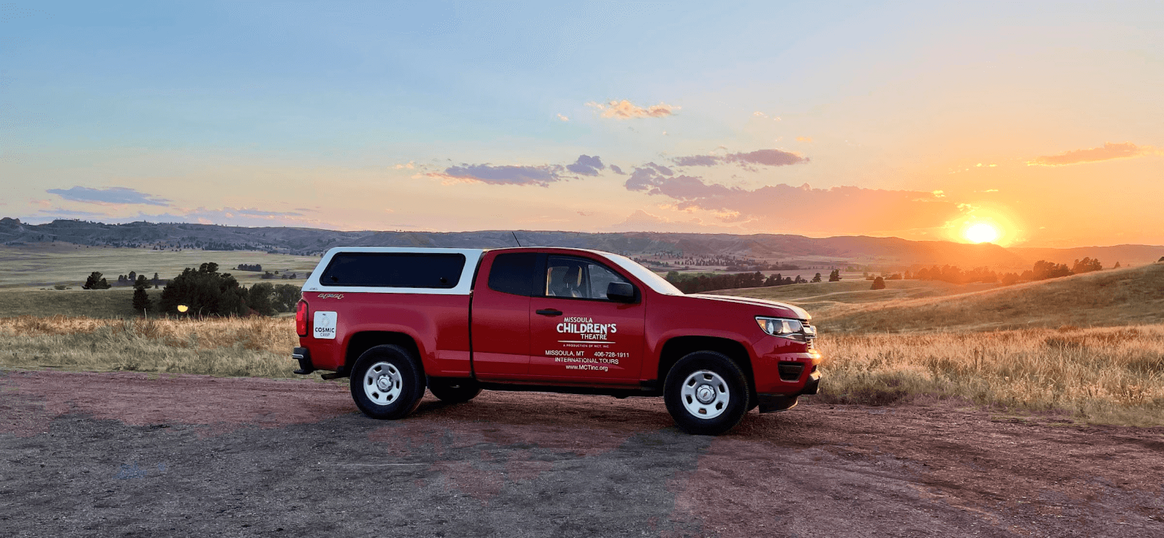 Photo of a Missoula Children's red truck during a sunset