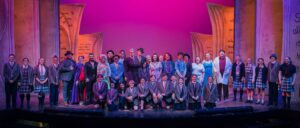 Group photo on stage of the performers in Matilda.