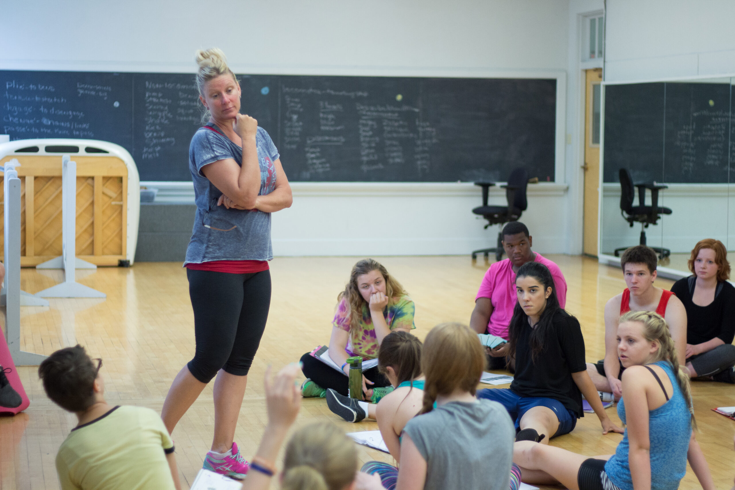 Students rehearsing play lines in a gymnasium.