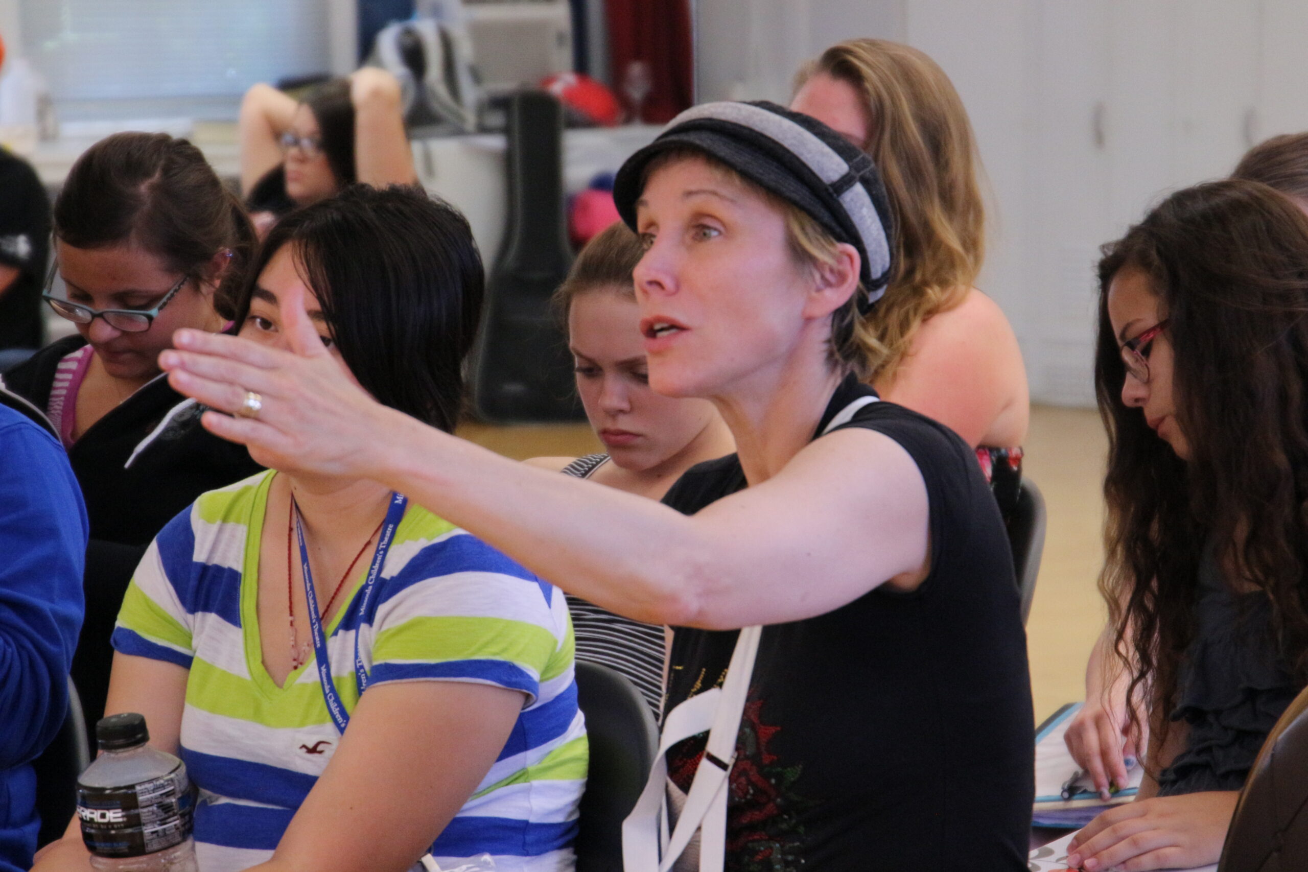 Close up of a teacher explaining something during a play rehearsal
