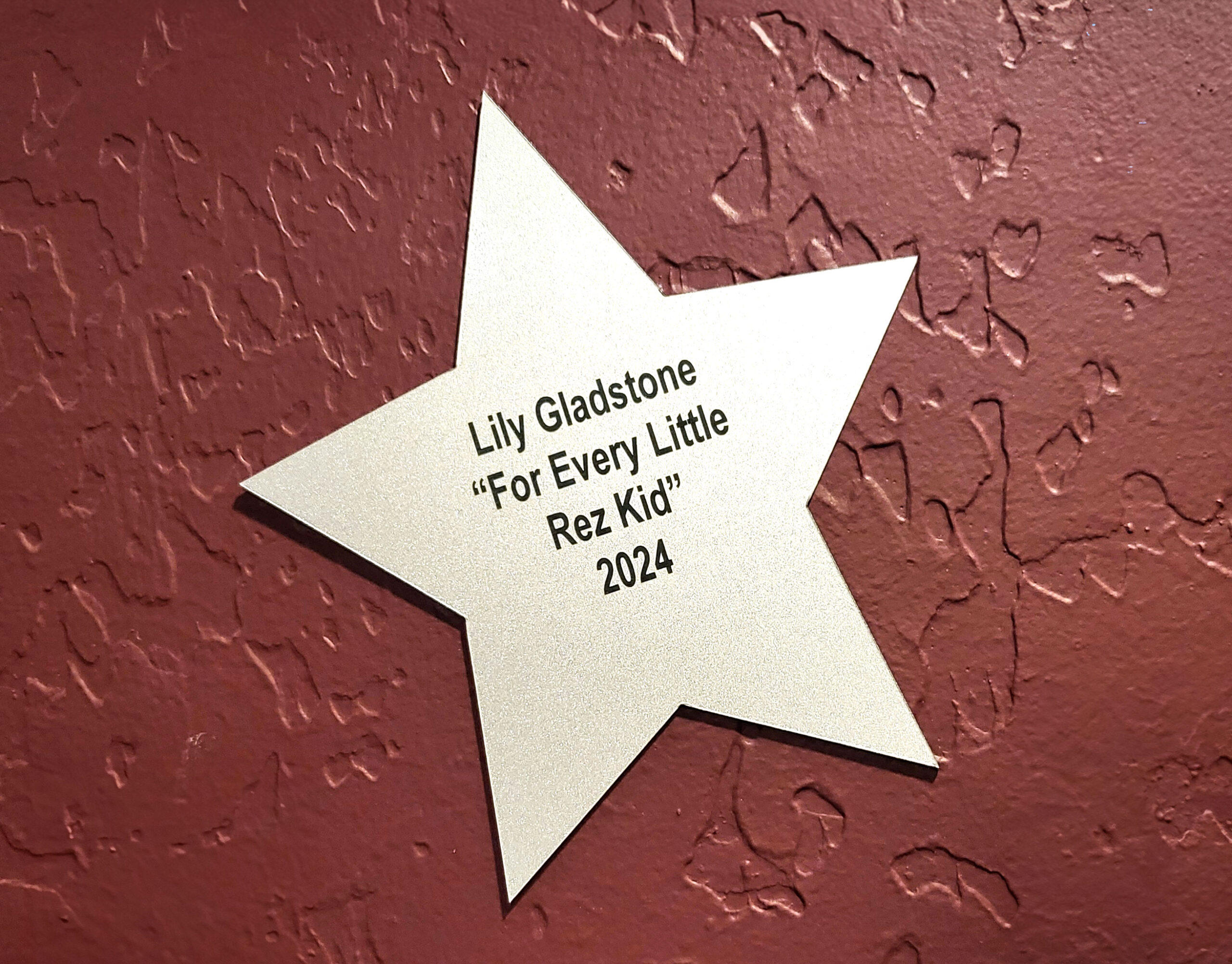 Photo of a star sign that says "Lily Gladstone - For Every Little Rez Kid 2024"