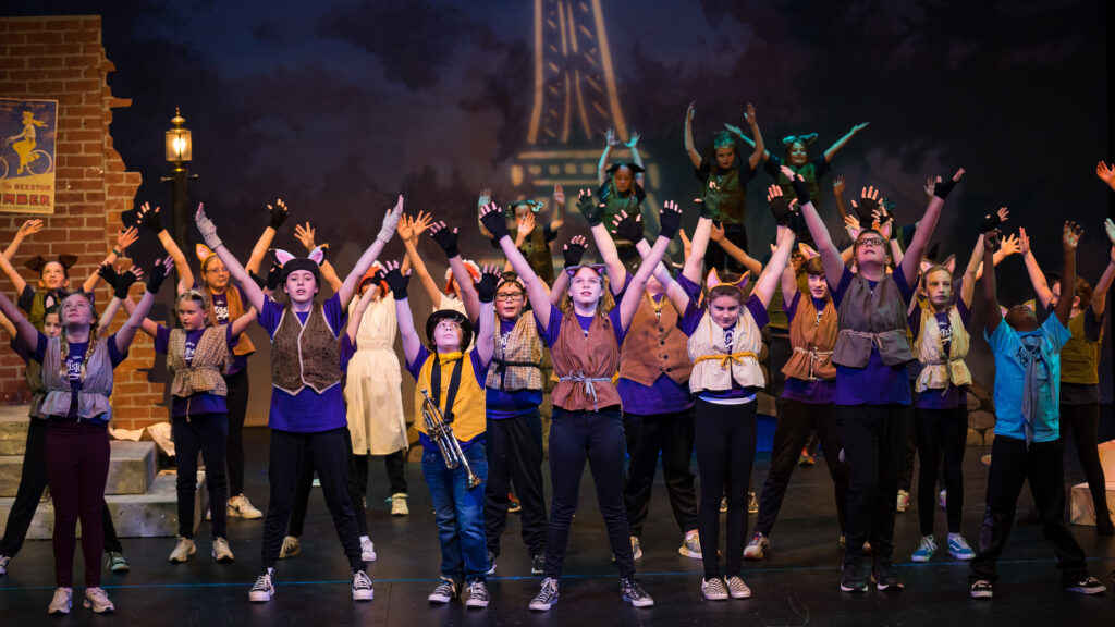 Group of young performers performing Aristocats.